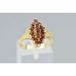 A 9CT GOLD GARNET RING, the tiered cluster of navette shape outline, claw set with circular cut