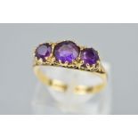 A LATE 20TH CENTURY 9CT GOLD AMETHYST HALF HOOP RING, fancy scroll detail to the sides and