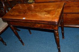 AN EARLY VICTORIAN FLAME MAHOGANY FOLD OVER CARD TABLE, the circular baize interior above turned