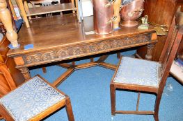 AN EARLY 20TH CENTURY CARVED OAK REFECTORY TABLE, on four moulded legs united by a cross