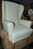 A WHITE LEATHER STYLE WING BACK CHAIR