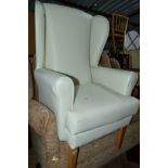 A WHITE LEATHER STYLE WING BACK CHAIR