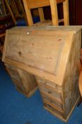 A LARGE PINE FALL FRONT BUREAU, with fitted pigeon hole interior on eight various drawers,