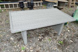 A RATTAN GARDEN TABLE (missing glass)