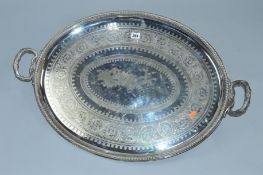 A LATE VICTORIAN ELKINGTON & CO SILVER PLATED TWIN HANDLED OVAL TRAY, foliate engraved decoration,