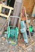 A WOODEN HALF RAKE, hose reels, a cast iron bench ends with supports, and a quantity of garden tools