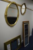 A MODERN OVAL WALL MIRROR, a smaller oval mirror and three various other wall mirrors (5)