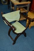 AN OAK FRAMED SAVONAROLA CHAIR, with green velour upholstery