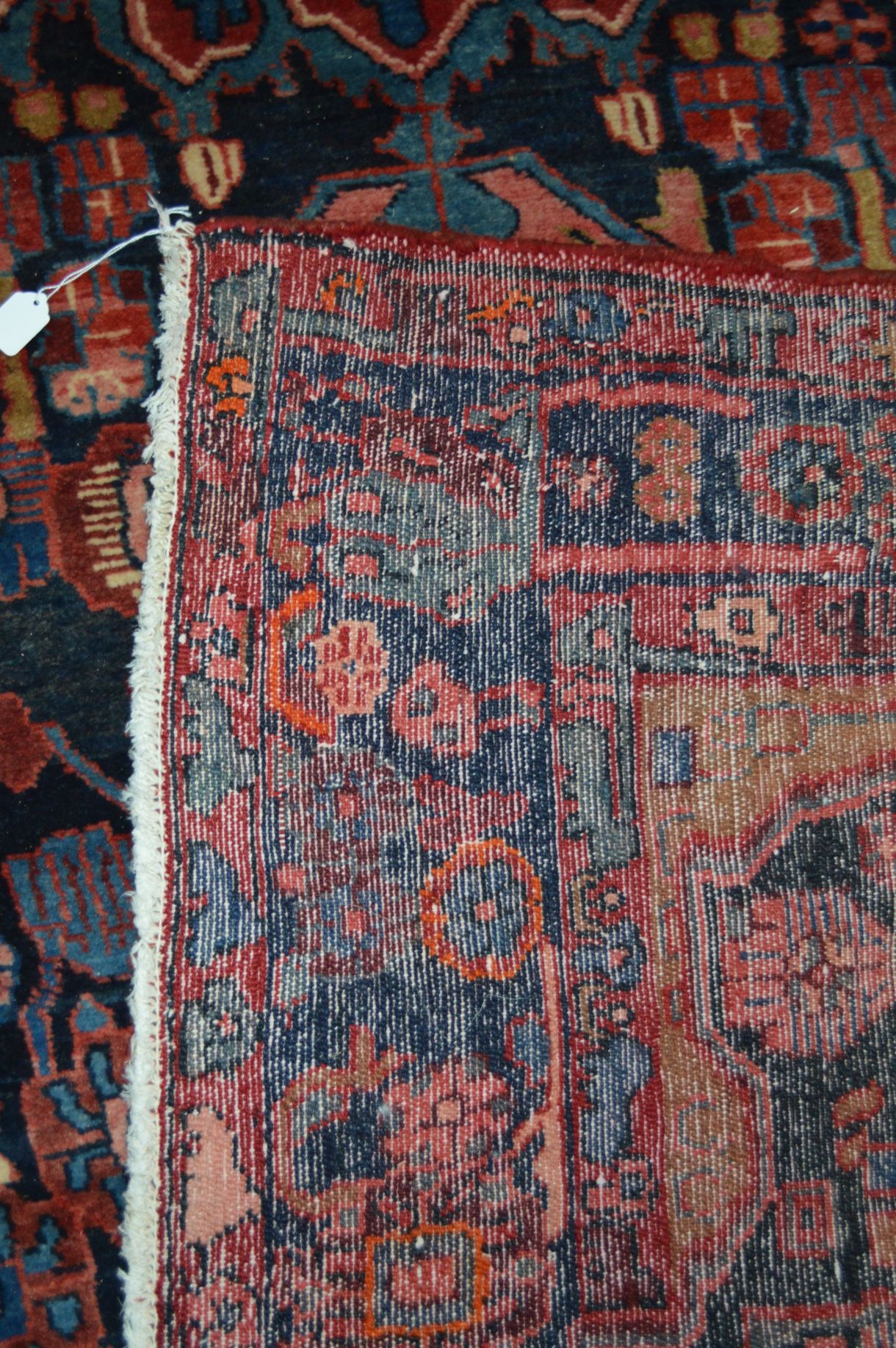 A 20TH CENTURY RED AND BLACK GROUND WOOLLEN CARPET SQUARE, with foliate and animal designs, (heavily - Image 3 of 4