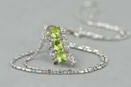 A GOLD GEM PENDANT, designed as a slightly curved row of three green oval gems flanked by offset