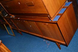 A TEAK 1970'S SIDEBOARD, with beech lining flanked by three drawers, fall front section and double