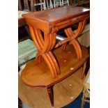 A YEW WOOD NEST OF THREE TABLES, on a cross framed base, a similar coffee table and a drop leaf