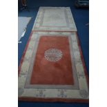 A MODERN CHINESE WOOLLEN RUG, orange and cream ground, width 182cm x 120cm, together with a