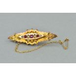 A LATE VICTORIAN RUBY AND SEED PEARL BROOCH, measuring approximately 42mm in length applied bead and