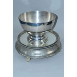 A LATE 19TH/EARLY 20TH CENTURY MIRRORED AND SILVER PLATED WEDDING CAKE STAND, of circular form,