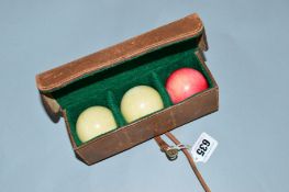 A CASED SET OF THREE IVORY BILLIARD BALLS, two white and one red
