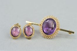 A LATE 20TH CENTURY AMETHYST BAR BROOCH, a large oval mixed cut amethyst measuring approximately