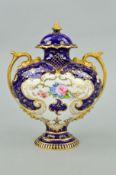 A ROYAL CROWN DERBY TWIN HANDLED COVERED PEDESTAL VASE, floral decorated insert with colbalt blue