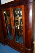 A GEORGIAN FLAME MAHOGANY BEVELLED MIRROR TWO DOOR WARDROBE, above a single long drawer and