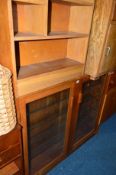 A TEAK GLAZED TWO DOOR BOOKCASE, and another teak bookcase (2)