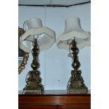 A PAIR OF 20TH CENTURY BRASSED TABLE LAMPS, with seated putti detail and shades