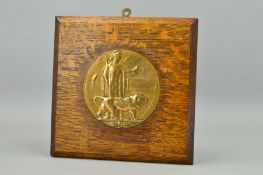 A WWI MEMORIAL DEATH PLAQUE, mounted on a wooden frame, sadly the plaque has been heavily polished