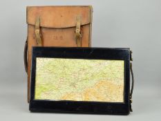 A BROWN LEATHER CASE WHICH CONTAINS A WOODEN CONSTRUCTED ROLLING DESIGN MAP OF THE U.K, the case