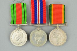 A GROUP OF THREE WWII MEDALS, Africa Service medal, named C284724 F. Abrahams, Defence and War medal