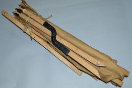 A WWII ERA POSSIBLY U.S.A FORCES ISSUE FOLDING CAMP BED, tan coloured, with wooden poles and metal