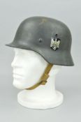 A WWII GERMAN 3RD REICH HEER M1935 HELMET, with liner strap complete, with side decals which may