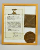 A GLAZED FRAME CONTAINING A WWI MEMORIAL DEATH PLAQUE, with card envelope, together with a
