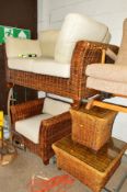 A WICKER FOUR PIECE CONSERVATORY SUITE comprising of a two seater sofa, chair, coffee table and