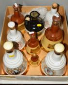 EIGHT BELLS WHISKY CERAMIC DECANTERS and one Rutherford's Whisky Decanter, contents ranging from one