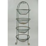 A GREEN PAINTED METAL FOUR TIER VEGETABLE RACK, circular removable baskets, on scrolled feet, height