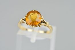 A CITRINE RING claw set with circular citrine to the open tapered shoulders, stamped 9ct, ring