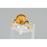 A CITRINE RING claw set with circular citrine to the open tapered shoulders, stamped 9ct, ring