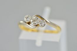 A THREE STONE DIAMOND CROSSOVER RING, designed as three graduated single cut diamonds within