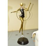 A DECO STYLE BRASS AND BRONZED FIGURE WITH A HOOP, approximate height 59cm (hoop broken and foot