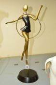 A DECO STYLE BRASS AND BRONZED FIGURE WITH A HOOP, approximate height 59cm (hoop broken and foot