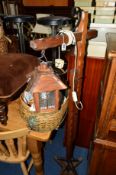 AN OAK FRAMED STANDING LANTERN on an adjustable stand