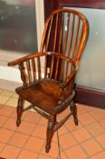 A 19TH CENTURY STAINED ASH WINDSOR HOOP AND SPINDLE BACK ARMCHAIR, dished seat, turned legs and '