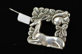 A REPRODUCTION BROOCH IN THE STYLE OF GEORG JENSEN, cast with squirrel, deer and leaves, stamped