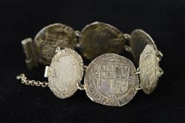 A SILVER COIN BRACELET, designed as six early English coins to the tubular bar clasp, length