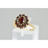 A LATE 20TH CENTURY OVAL CLUSTER GARNET SET RING, ring size O, hallmarked 9ct gold, Birmingham,