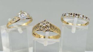 THREE 9CT GOLD GLASS RINGS, the first a seven stone ring, ring size N, the second a cluster ring,