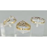 THREE 9CT GOLD GLASS RINGS, the first a seven stone ring, ring size N, the second a cluster ring,