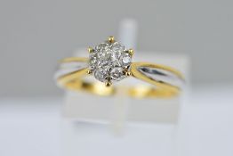 A BI-COLOUR DIAMOND CLUSTER RING, the cluster of brilliant cut diamonds to the white and yellow gold