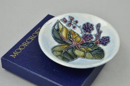 A BOXED MOORCROFT POTTERY TRINKET DISH, 'Blackberry' pattern, impressed and painted marks to base,