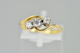 A THREE STONE DIAMOND RING, of cross over design, claw set with three graduated old cut diamonds,