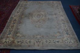 A CHINESE WOOLLEN CARPET SQUARE, green and cream ground, approximate size 272cm x 153cm